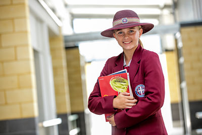 St Benedict's College female student with books